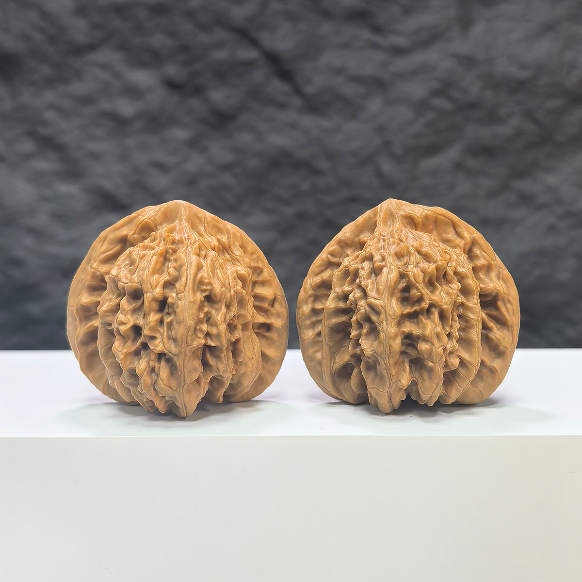 Pair of Peach Heart Concave Base Wenwan walnuts by Wenwan Art, deep-base with smooth peach-heart shape, 44mm x 42mm.
