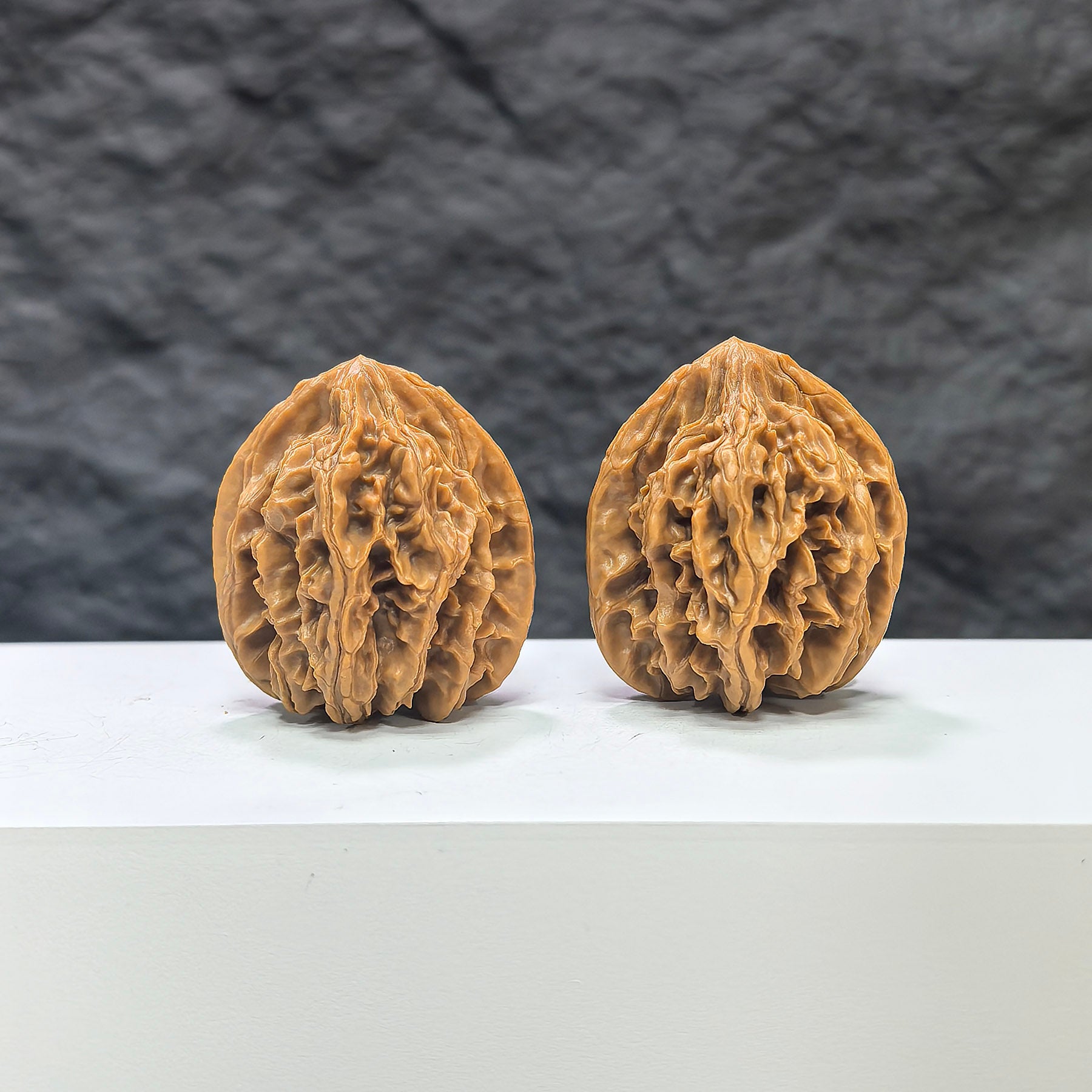 Pair of Tongtian Eight Classic Wenwan Walnuts from Wenwan Art, 33mm, featuring intricate natural wood grain and smooth polished surfaces.