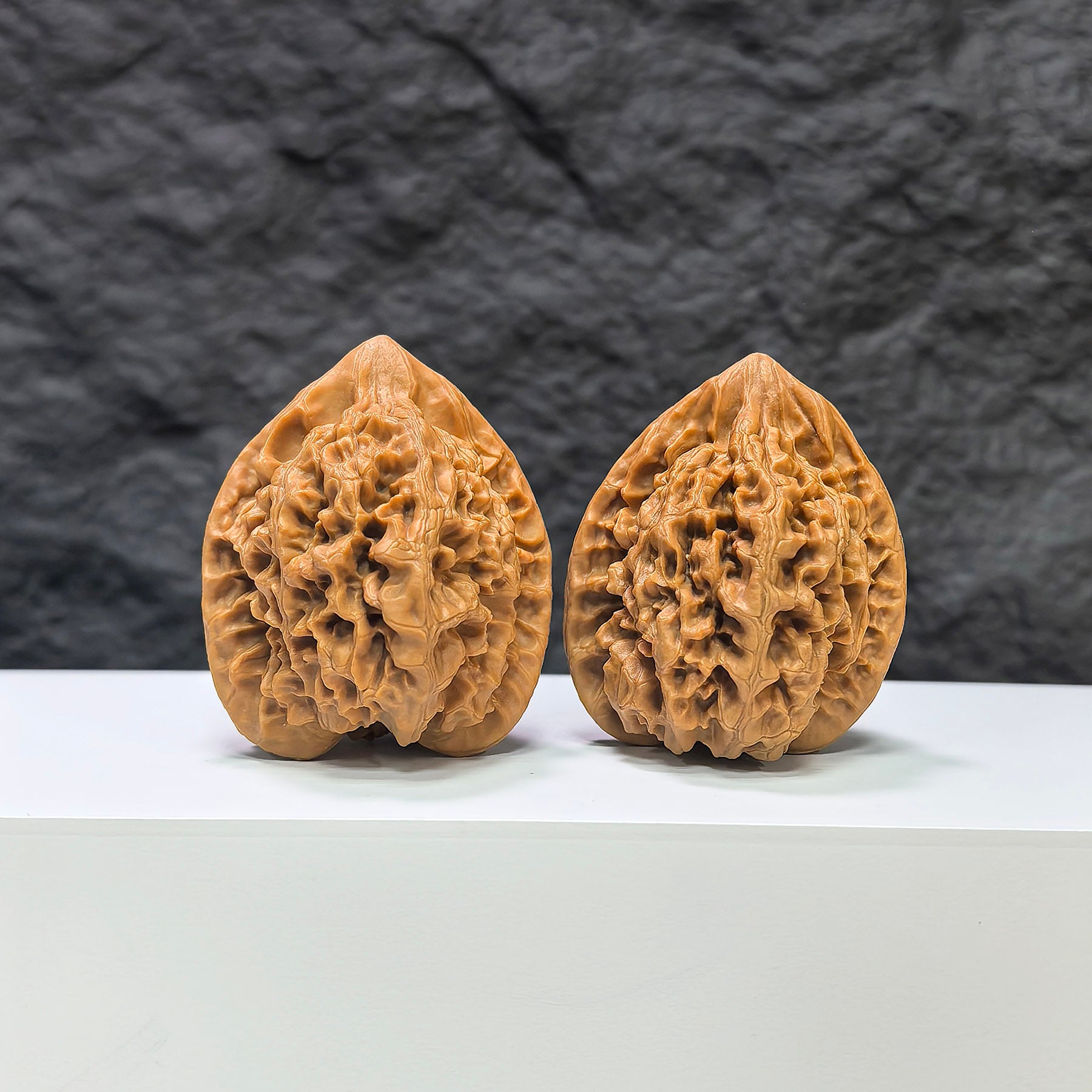 Pair of official Wenwan Walnuts from Wenwan Art, classic 39mm x 36mm walnut carvings with detailed natural wood grain.