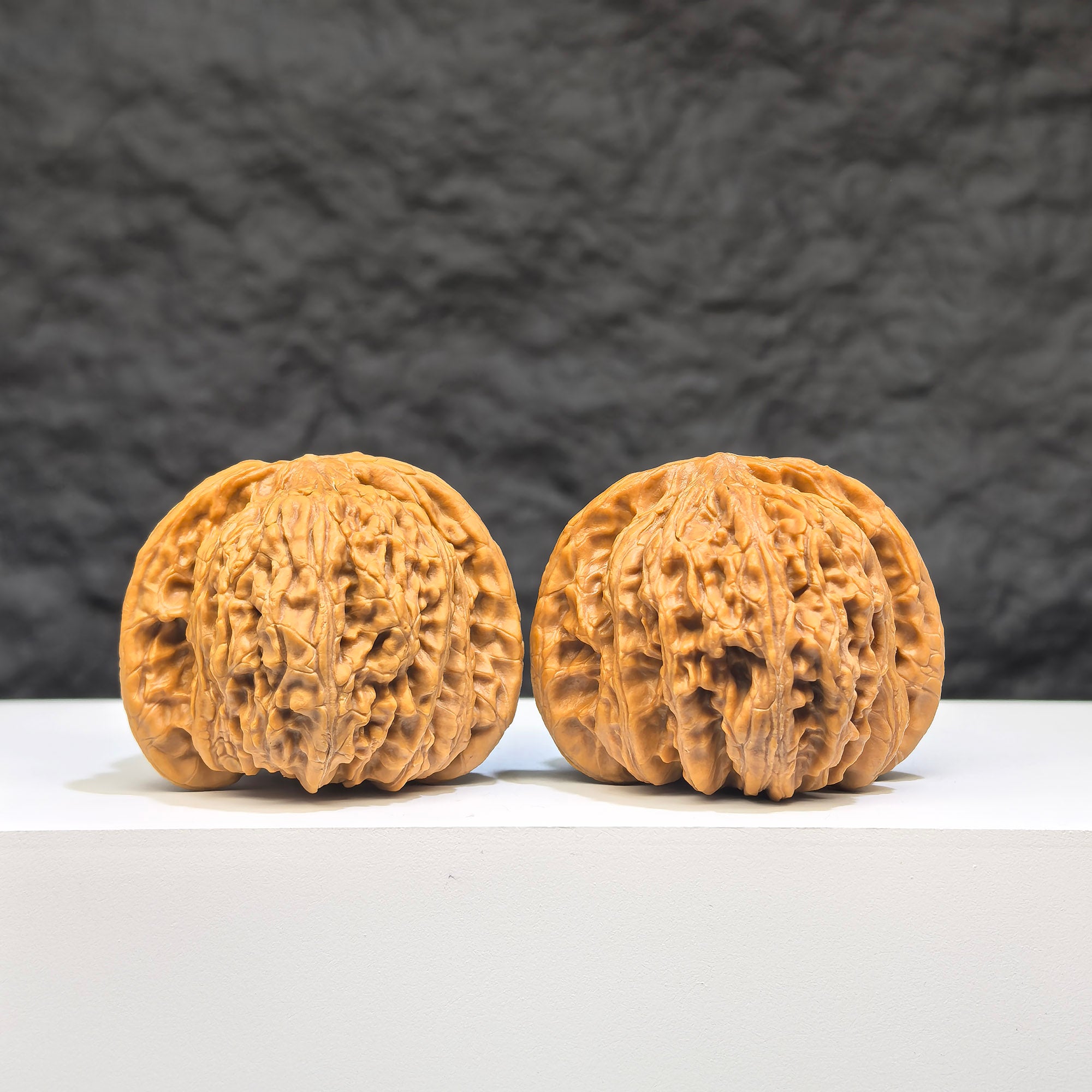 Pair of Wenwan Art "Ruby" classic Wenwan walnuts, 41mm x 37mm, featuring red gemstone-like appearance and detailed craftsmanship.