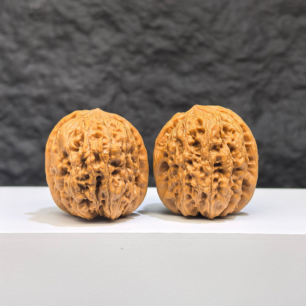 Pair of Wenwan Walnut miniatures, Pocket Yuhua Stone by Wenwan Art, 32mm size, showing detailed natural stone textures and colors.