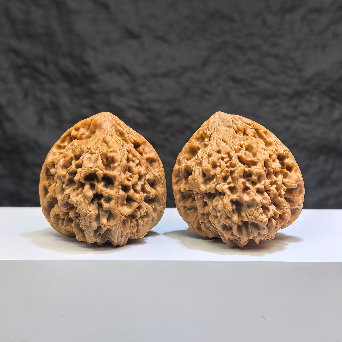 Pair of Classic Scholar Wenwan Walnuts by Wenwan Art, featuring 麒麟紋凹底 pattern, measuring 47mm by 44mm, hand-matched.
