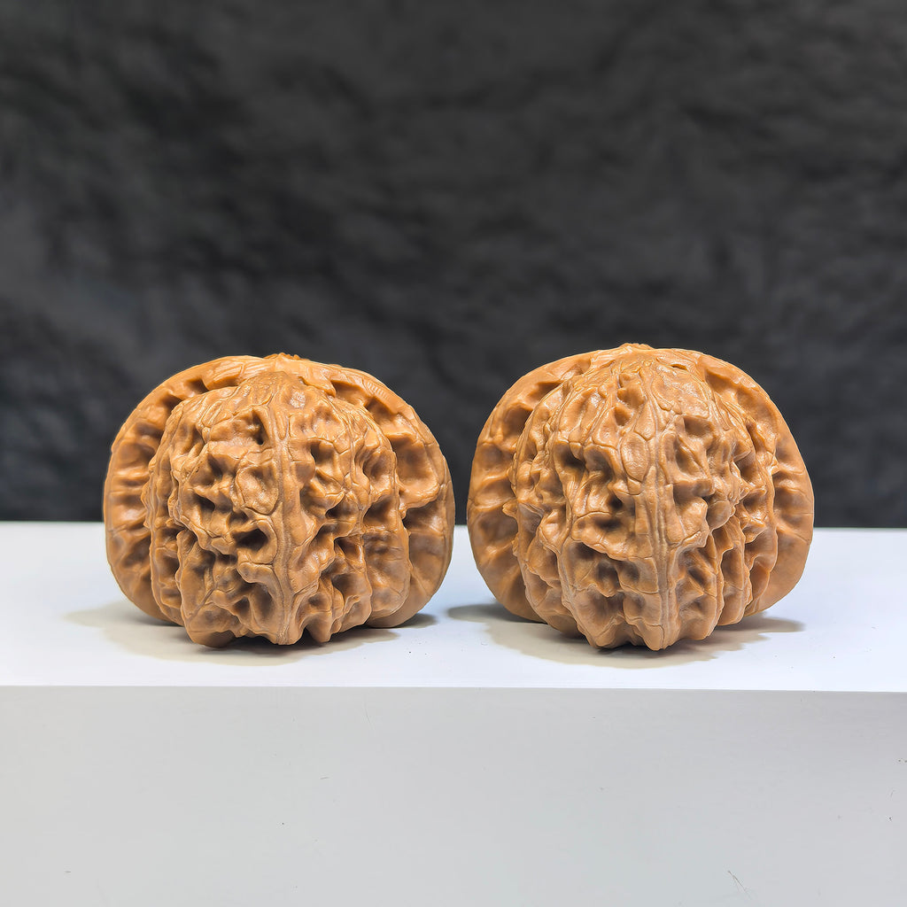 Pair of spherical white lion Wenwan walnuts from Wenwan Art, 38mm round-profile white walnut carvings with intricate lion designs.