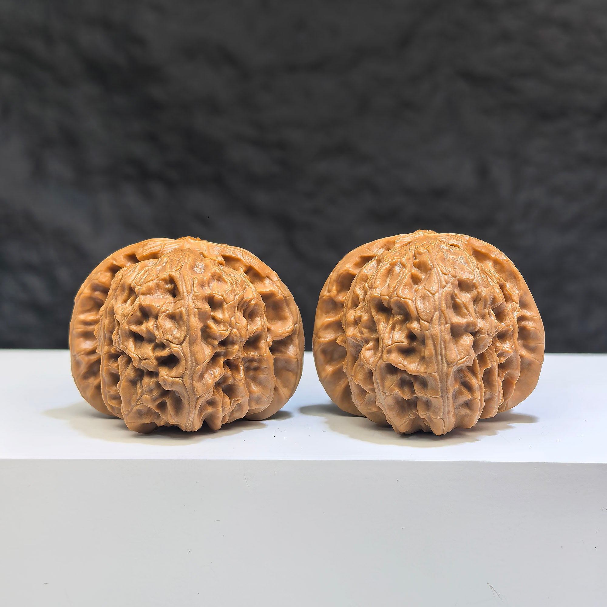 Pair of spherical white lion Wenwan walnuts from Wenwan Art, 38mm round-profile white walnut carvings with intricate lion designs.