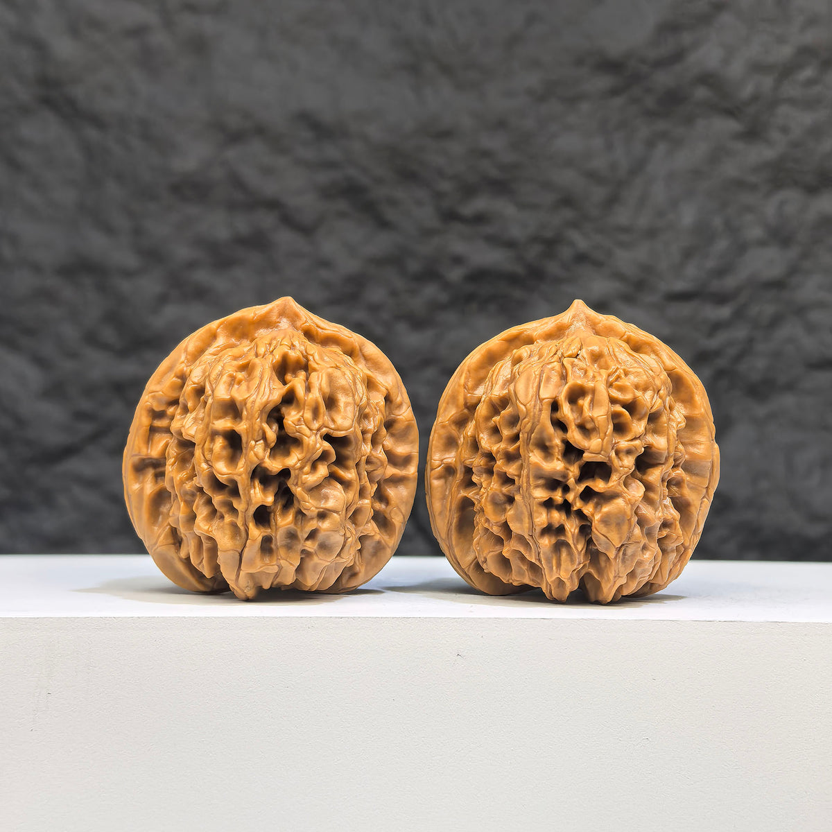Pair of Hundred Beasts Lion Head Wenwan walnuts by Wenwan Art, featuring detailed carved lion head designs, 38mm size.