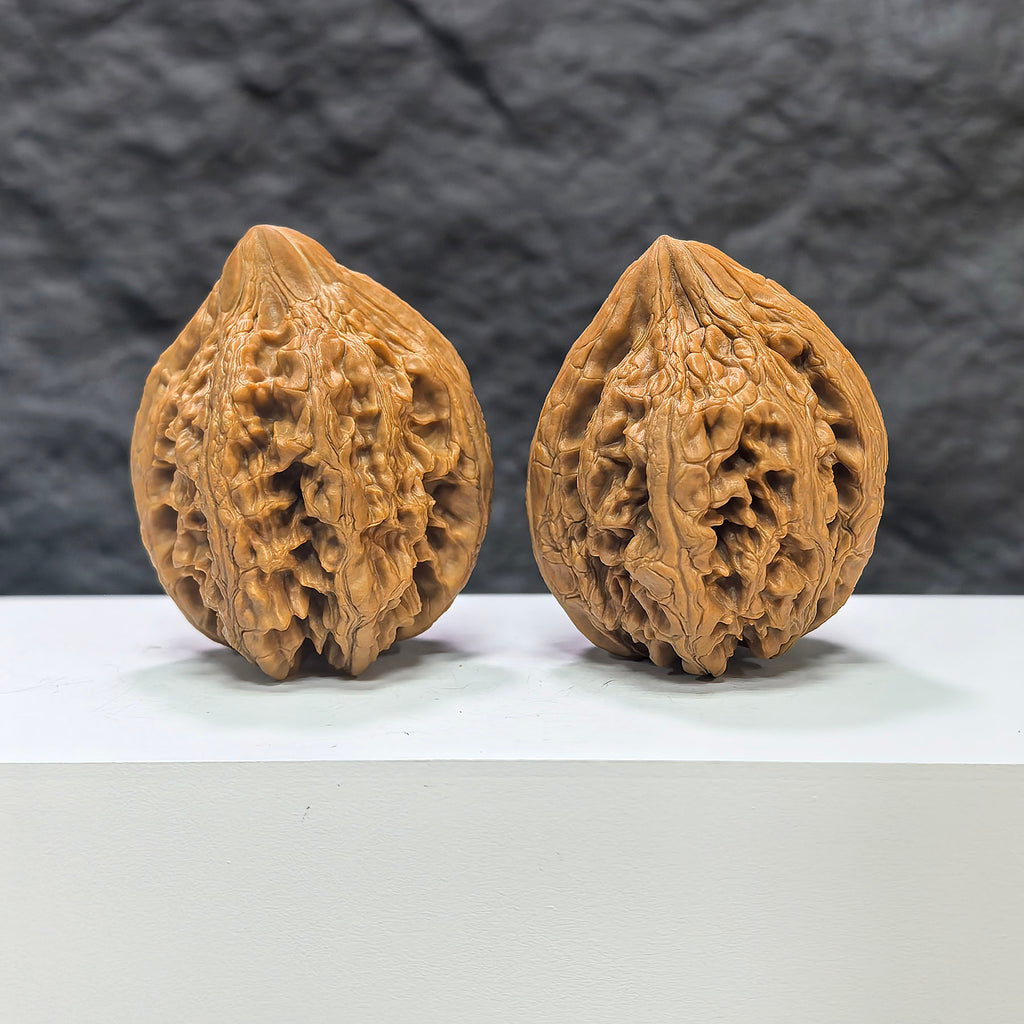 Pair of Dazhan Stone Wenwan Walnuts by Wenwan Art, 41mm x 42mm, showcasing detailed craftsmanship and natural stone textures.