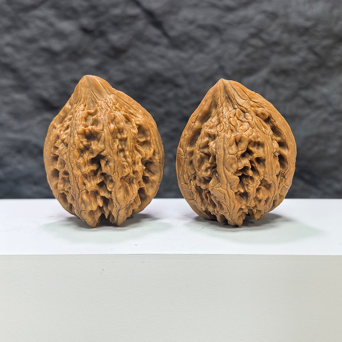 Pair of Dazhan Stone Wenwan Walnuts by Wenwan Art, 41mm x 42mm, showcasing detailed craftsmanship and natural stone textures.
