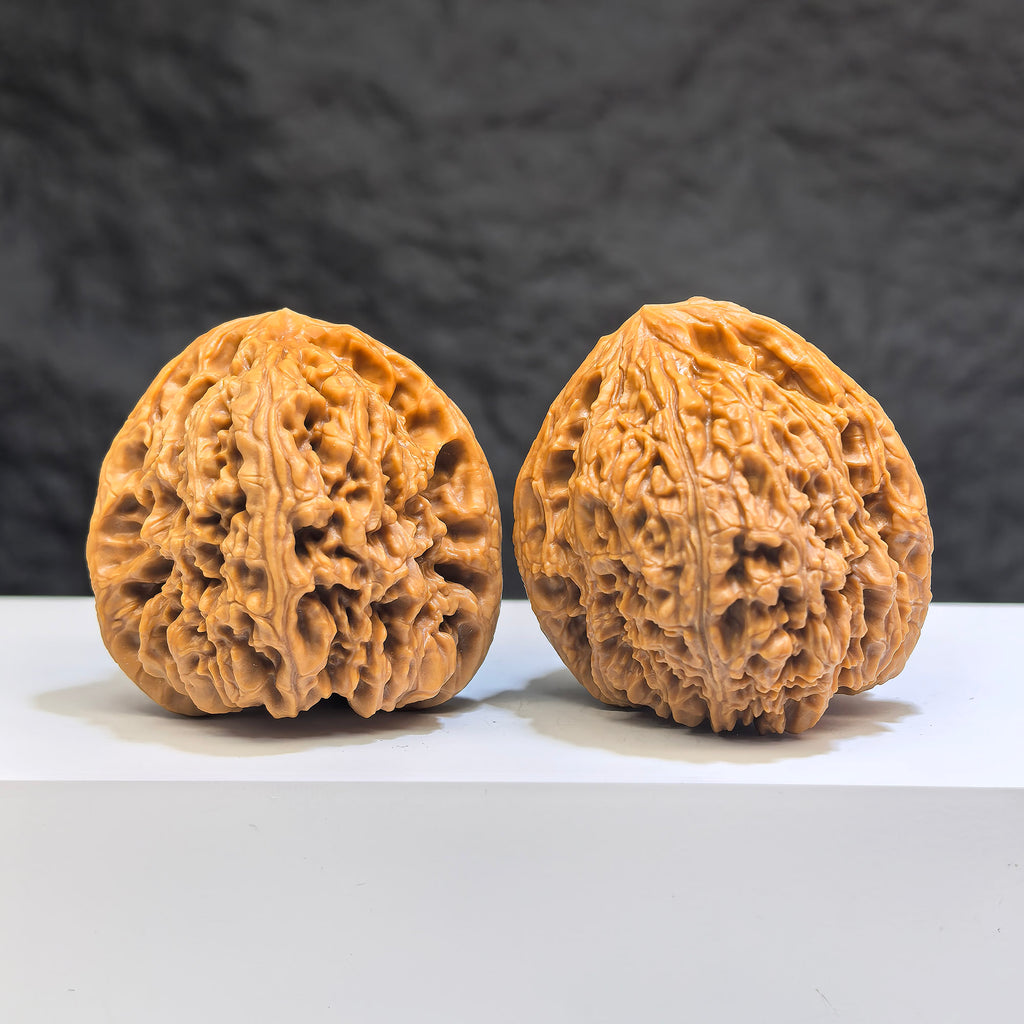 Pair of Nanjiangstone Wenwan walnuts from Wenwan Art, 40mm x 40mm, showing detailed natural stone texture and craftsmanship.