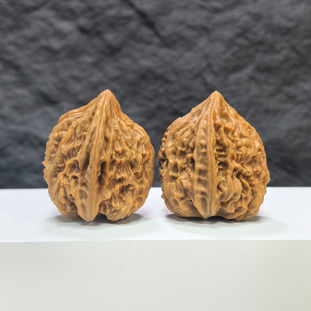 Pair of Beijing Chicken Heart Wenwan walnuts from Wenwan Art, 37-38mm, showcasing smooth, polished walnut carvings with natural wood grain.