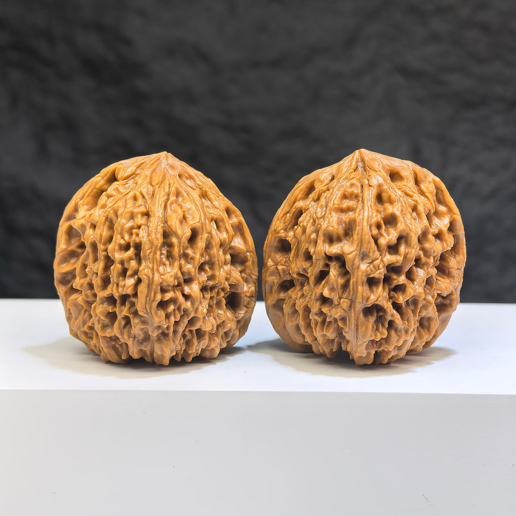 Pair of Nanjiangstone Wenwan walnuts from Wenwan Art, 41mm x 40mm, featuring smooth, polished stone surfaces with natural patterns.