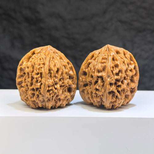 Pair of Nanjiangstone Wenwan walnuts from Wenwan Art, 41mm x 40mm, featuring smooth, polished stone surfaces with natural patterns.