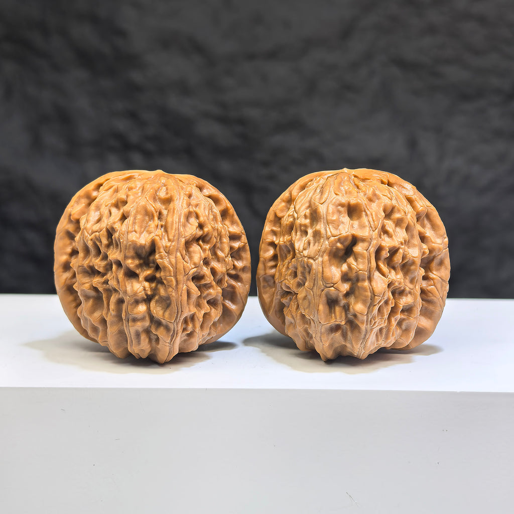 Pair of White Lion Wenwan Walnuts from Wenwan Art, featuring intricate carvings and natural walnut textures, 38mm x 39mm.