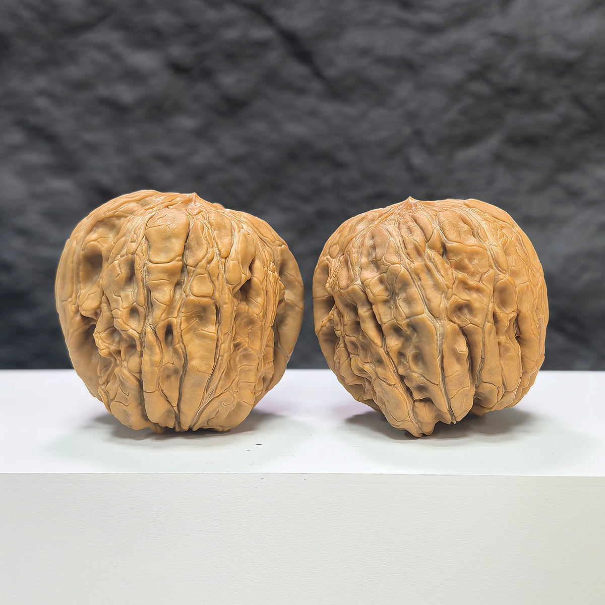 Pair of Wenwan Art Classic Scholar hand-matched Wenwan walnuts, 44mm x 46mm, showcasing detailed carved designs and natural walnut color.