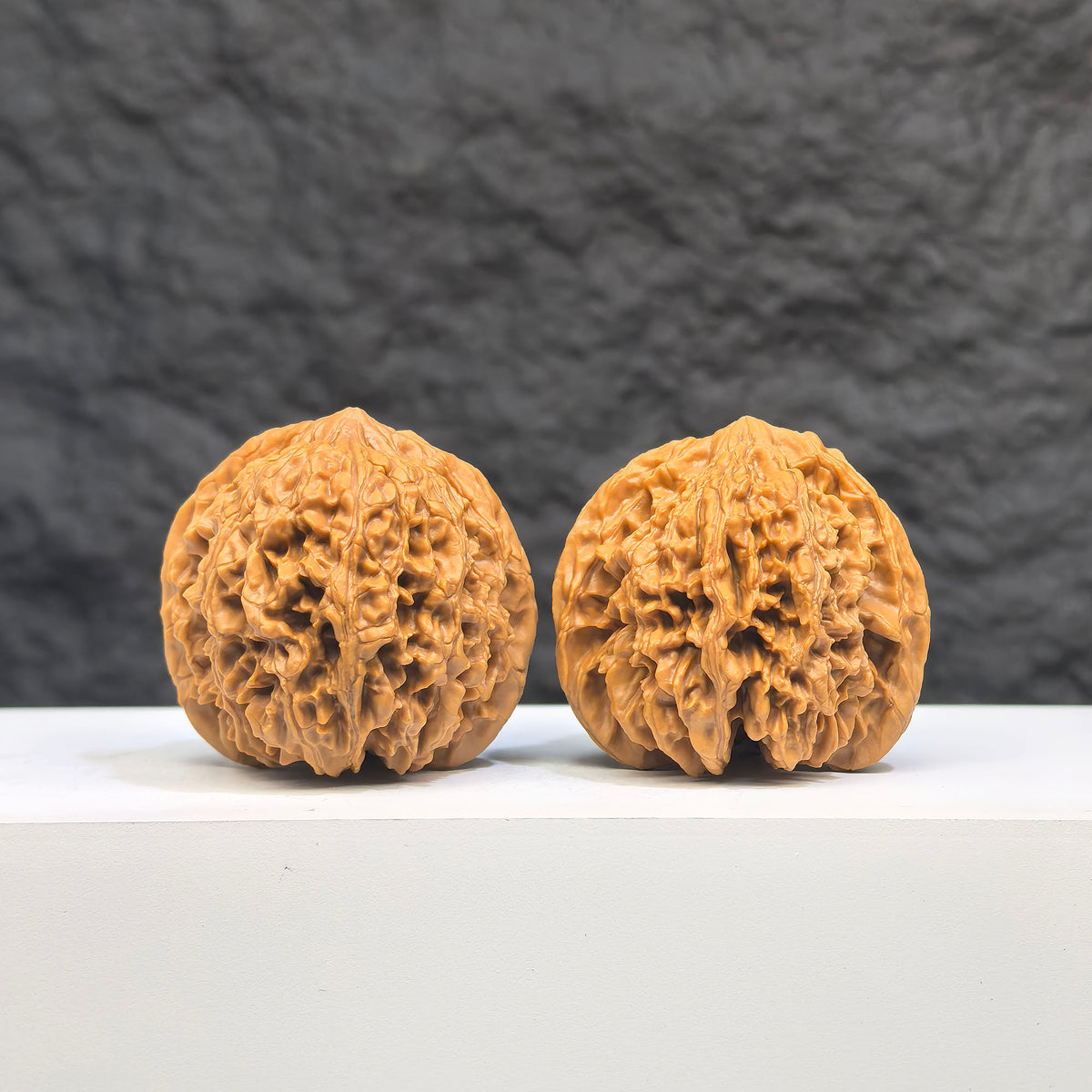 Pair of Babys Breath Full Stars Wenwan Walnuts by Wenwan Art, 38mm x 37mm, featuring intricate star patterns on smooth walnut surfaces.