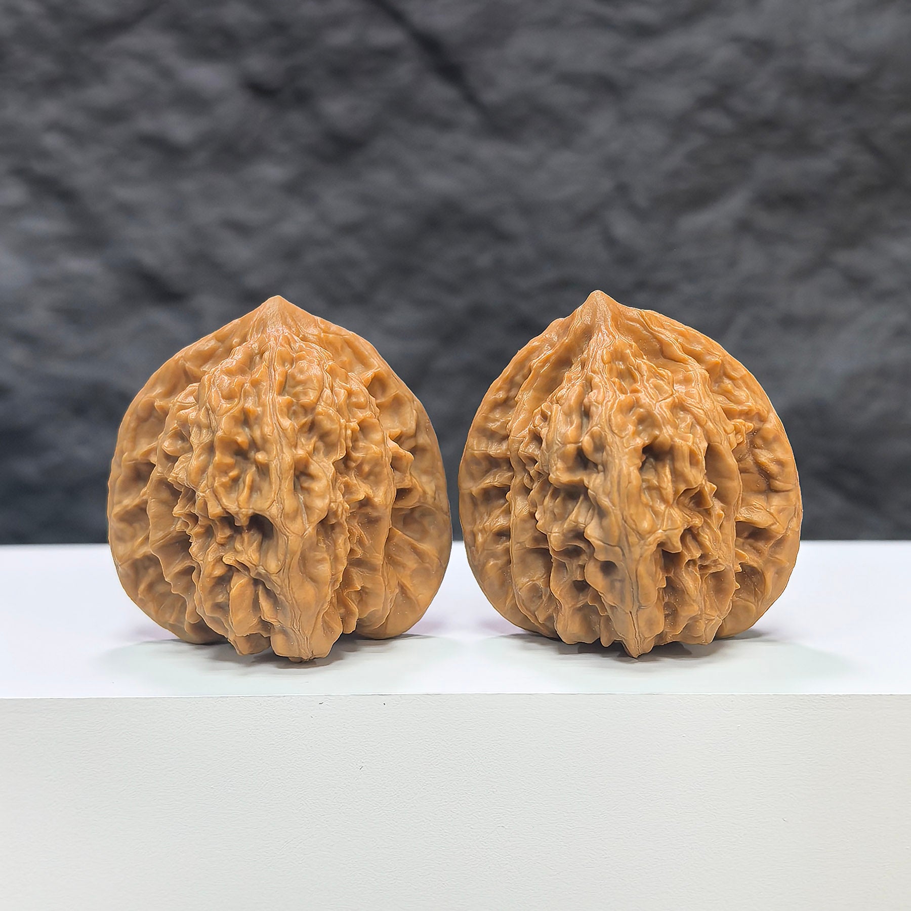 Pair of Peach Heart Concave Base Wenwan walnuts by Wenwan Art, deep-base, 39mm x 37mm, featuring smooth, polished surface and natural wood grain.