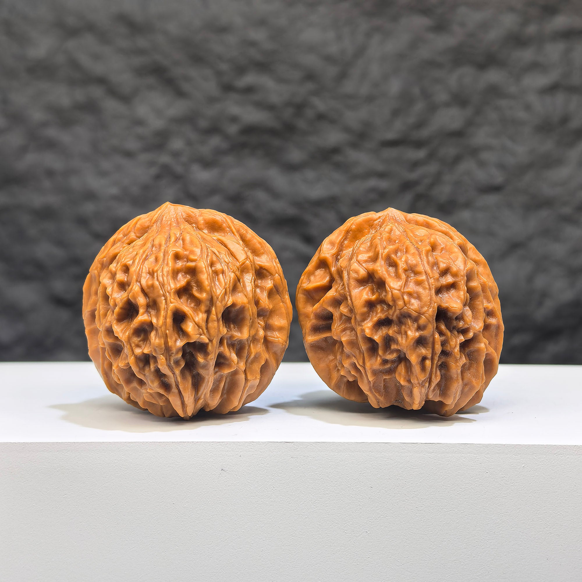 Pair of Wenwan Art Dragon Scale Wenwan walnuts, 36mm, with detailed textured surface and natural wood grain pattern.