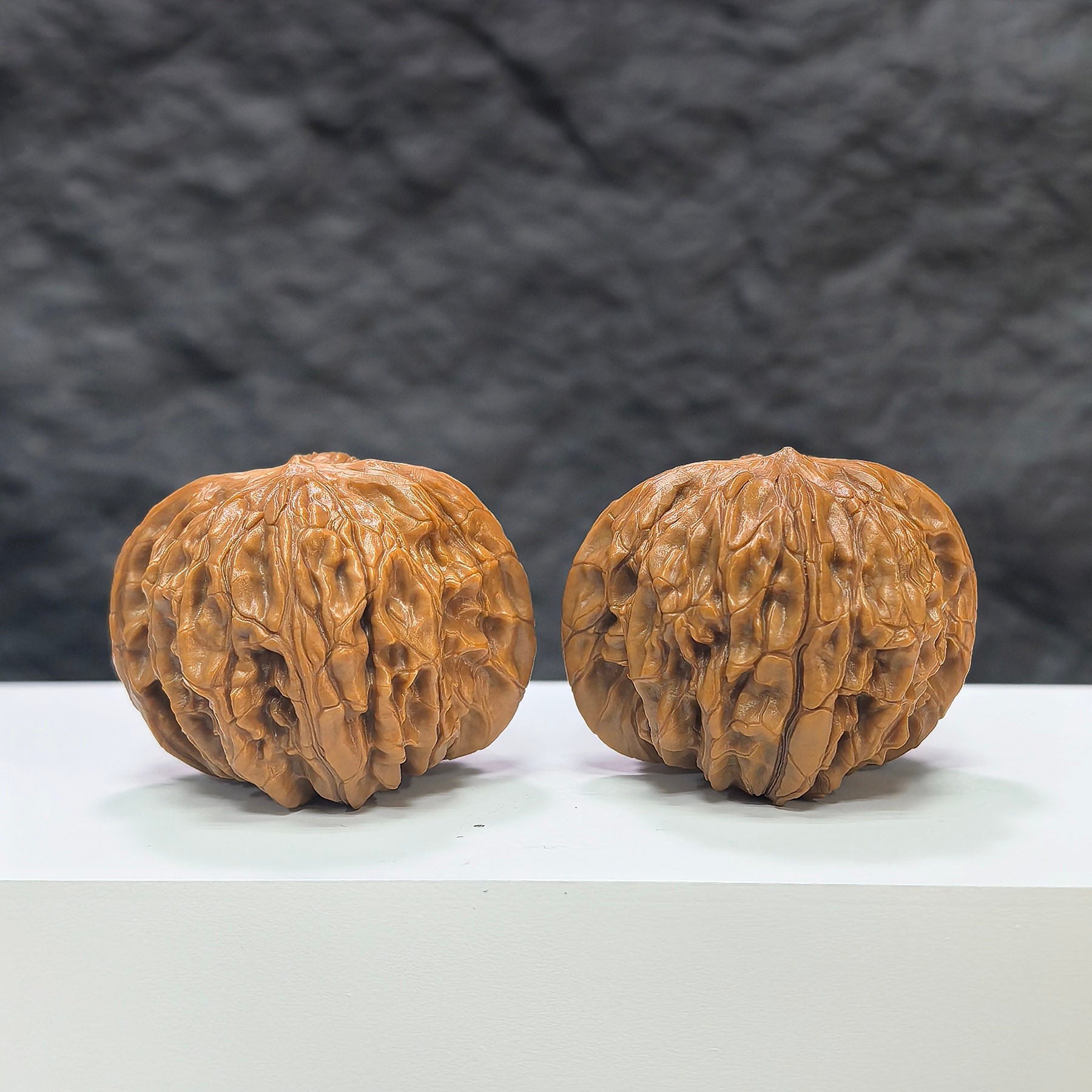 Pair of Classic Scholar Wenwan Walnuts by Wenwan Art, hand-matched, 41mm x 39mm, showing detailed carved surfaces.