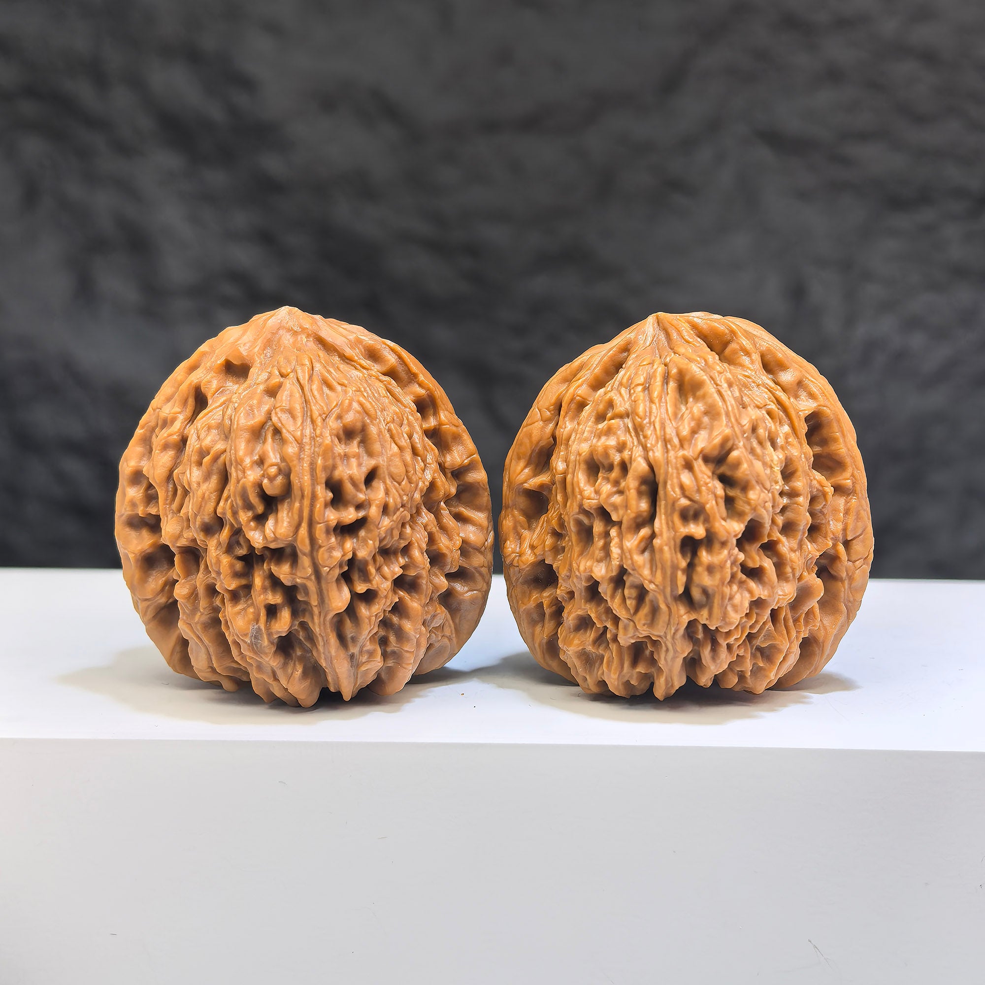 Pair of Nanjiangstone Wenwan walnuts from Wenwan Art, 38mm classic walnut carvings with intricate details and natural stone texture.