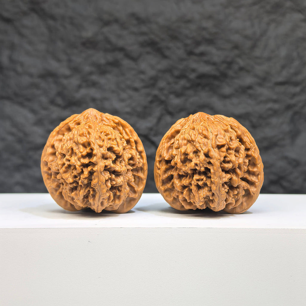 Pair of Wenwan Art Babys Breath Full Stars Wenwan walnuts with intricate star patterns, 38mm x 37mm, showcasing detailed craftsmanship.
