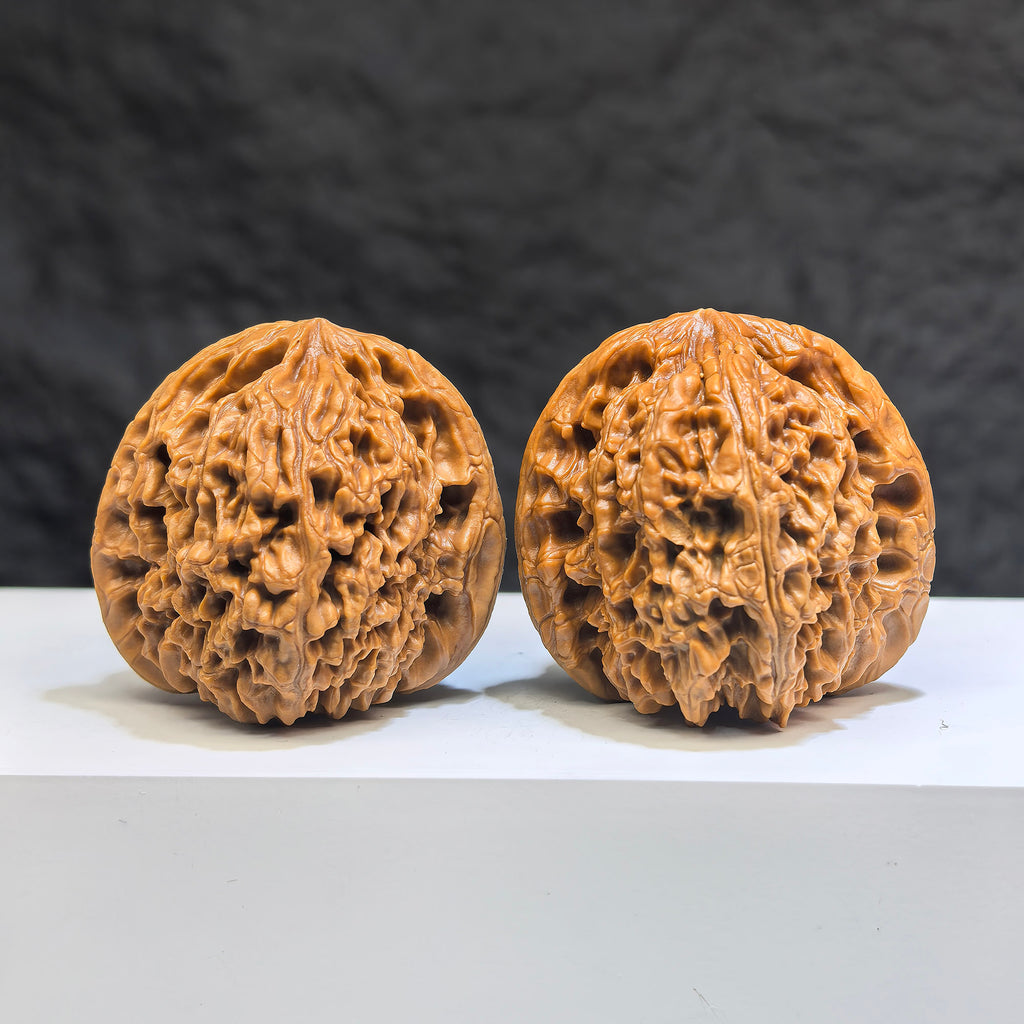 Pair of Wenwan Art Tri-Angular Concave Base Nanjiangstone deep-base walnuts, 40mm, showcasing smooth, polished surfaces and unique shape.