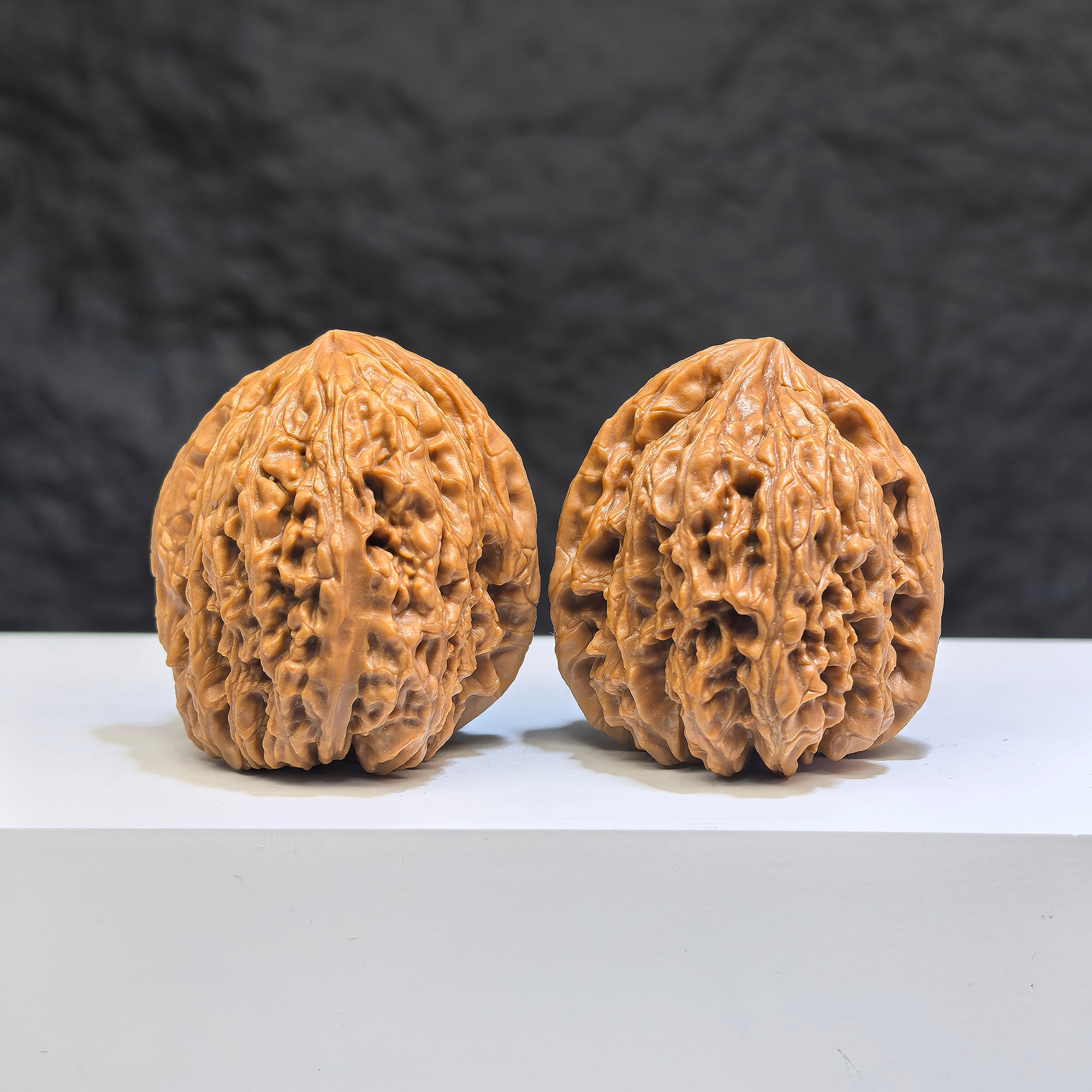 Pair of Nanjiangstone Wenwan walnuts from Wenwan Art, 36mm, showing smooth, polished walnut shapes with natural stone texture.