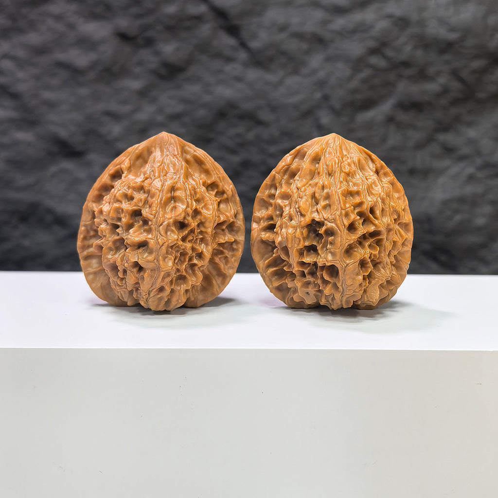 Pair of Golden Kylin Wenwan walnuts from Wenwan Art, featuring intricate carvings, measuring 40mm by 38mm, displayed side by side.