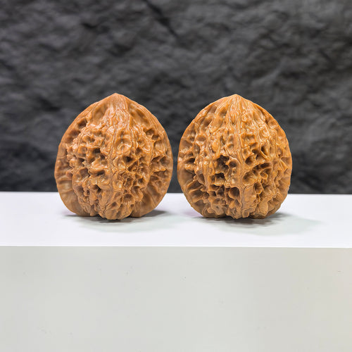 Pair of Golden Kylin Wenwan walnuts from Wenwan Art, featuring intricate carvings, measuring 40mm by 38mm, displayed side by side.
