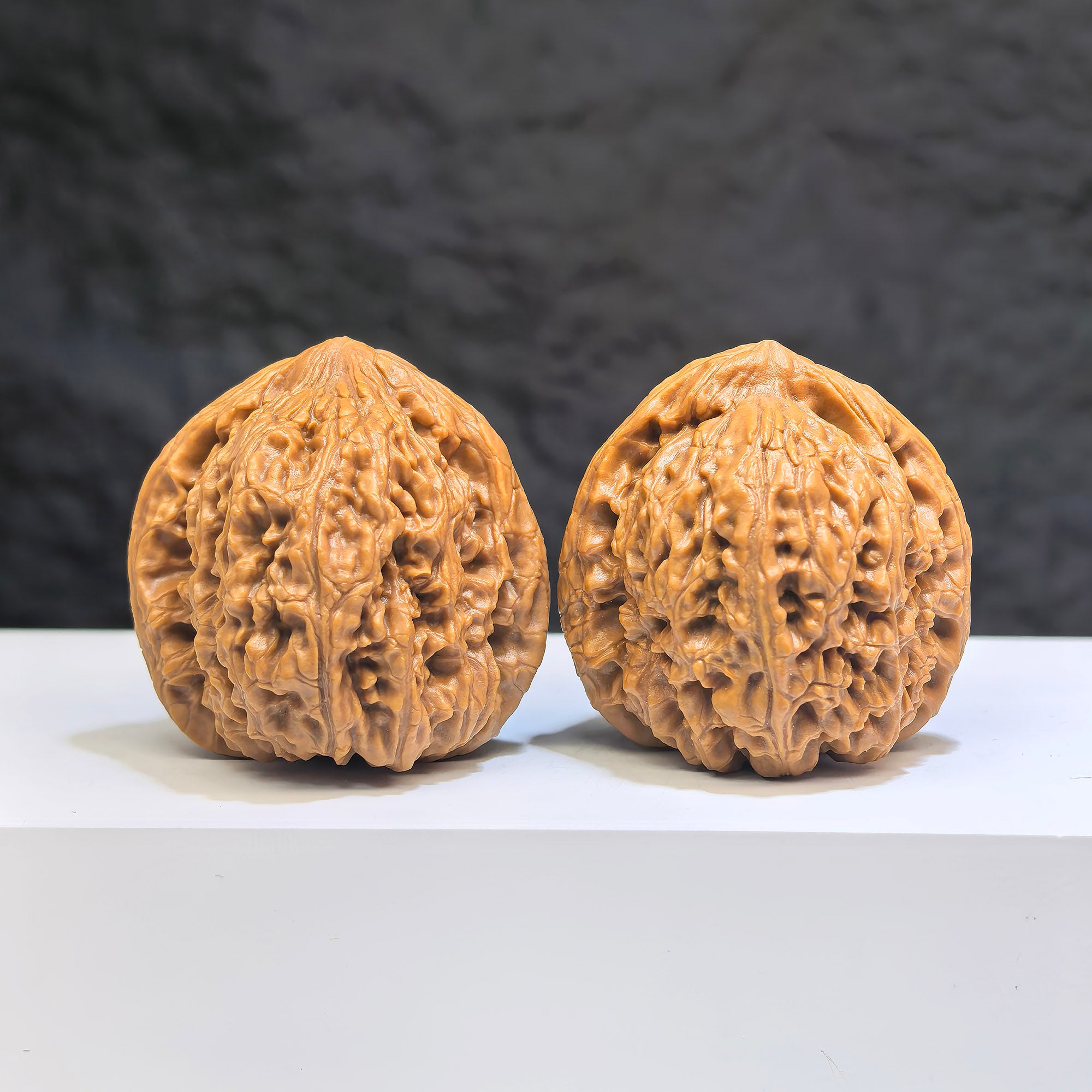 Pair of Nanjiangstone Wenwan walnuts from Wenwan Art, 38mm size, showcasing smooth, natural stone textures and detailed carving.