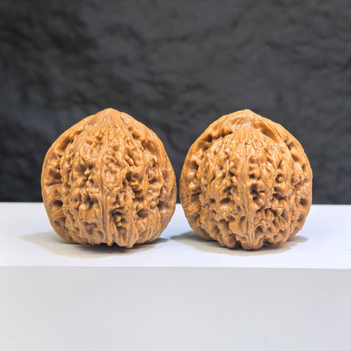 Pair of Nanjiangstone Wenwan walnuts from Wenwan Art, 38mm size, showcasing smooth, natural stone textures and detailed carving.