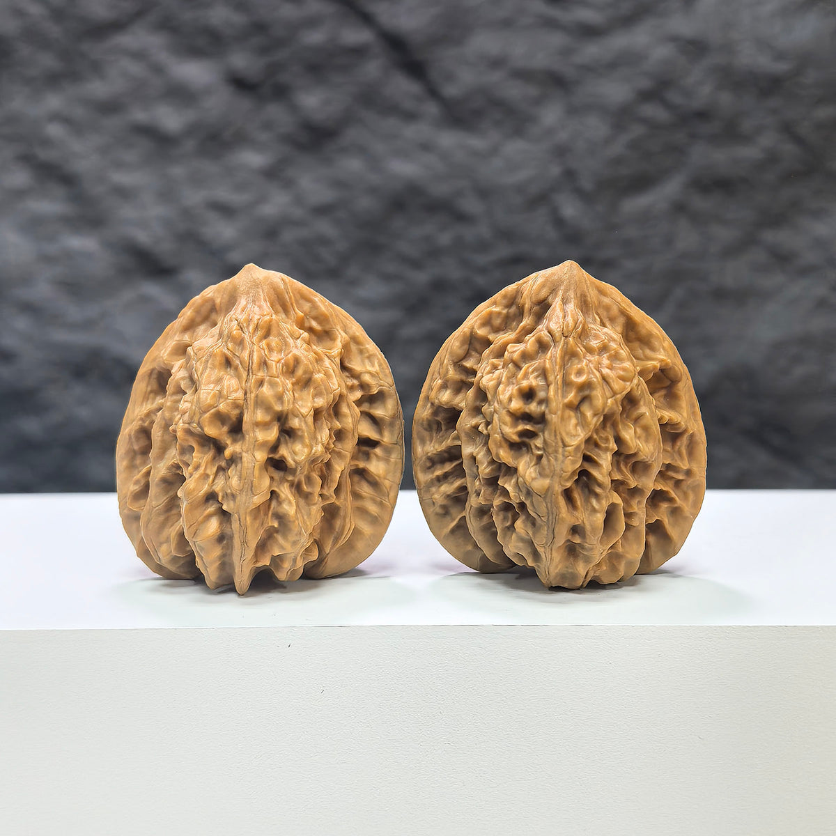 Pair of Xiayunling Classic Wenwan Walnuts from Wenwan Art, 37mm x 35mm, showcasing detailed natural walnut carvings.
