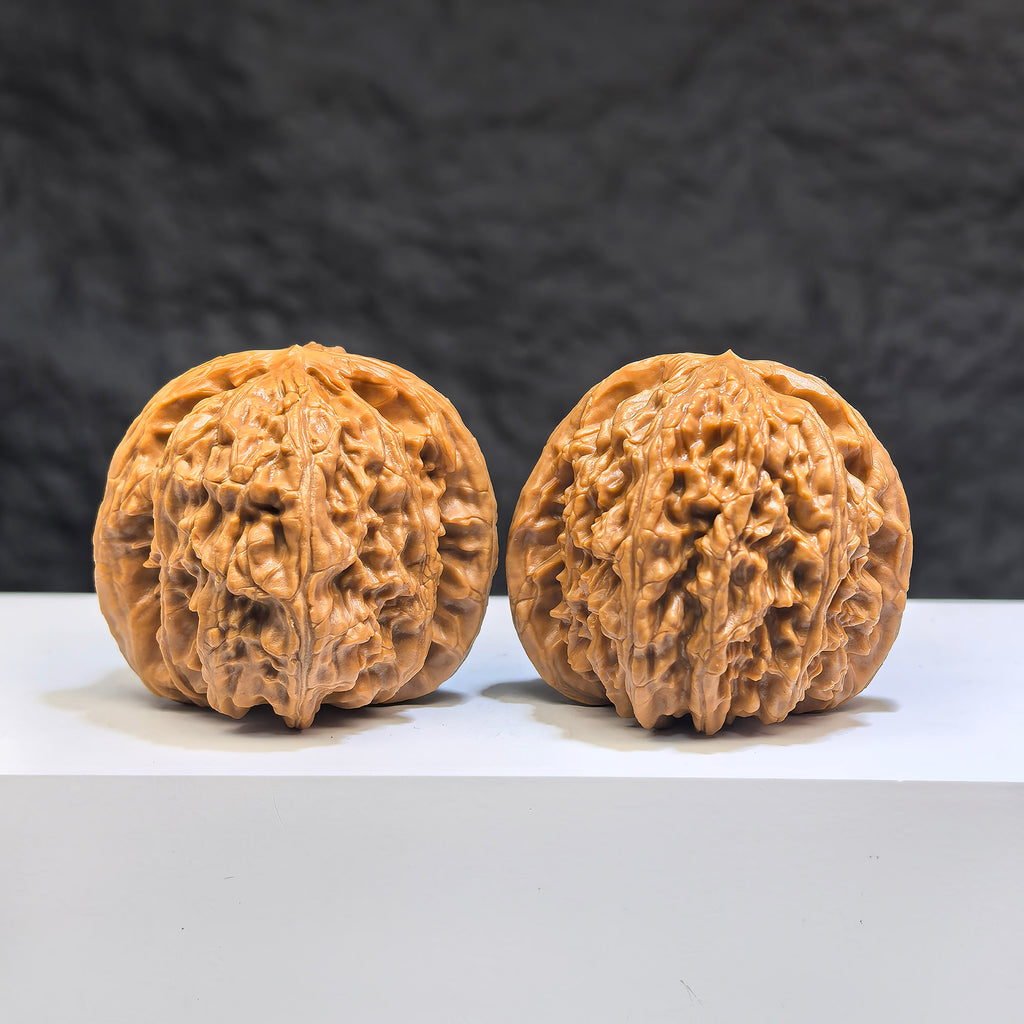 Pair of White Lion Wenwan Walnuts from Wenwan Art, 39mm size, detailed white lion carvings on polished walnut surfaces.