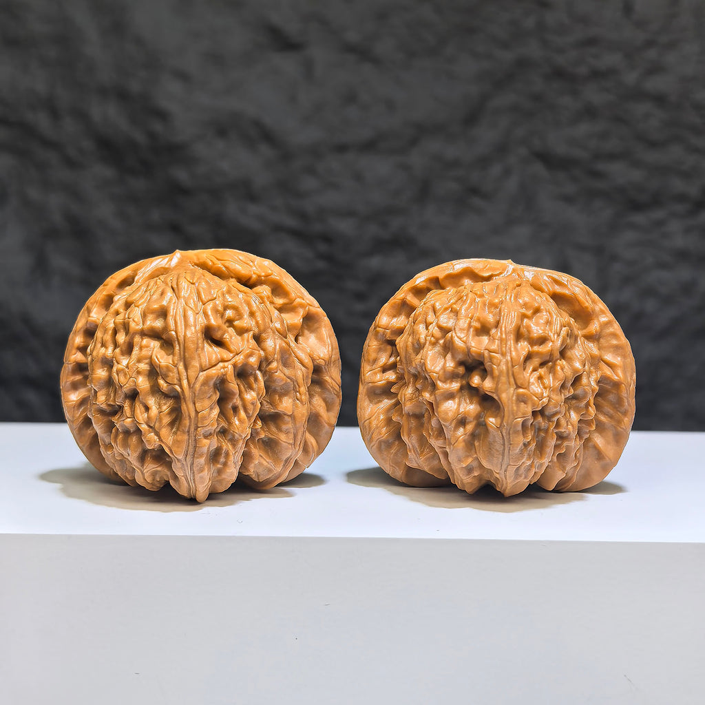 Pair of spherical white lion Wenwan walnuts from Wenwan Art, round profile, 43mm and 40mm, detailed white lion carvings.