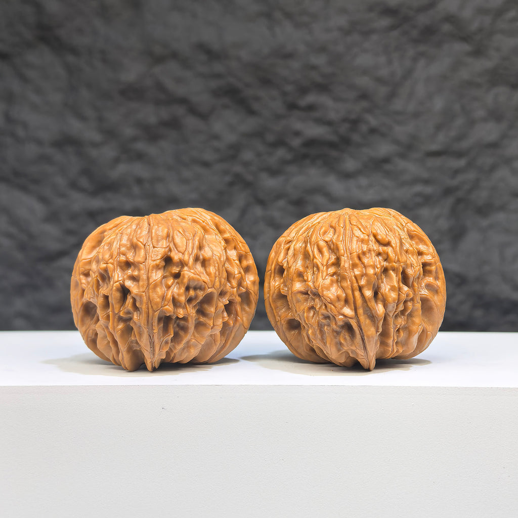 Pair of red shell Wenwan walnuts from Wenwan Art, featuring classic millstone design, 42mm x 38mm size, traditional craftsmanship.