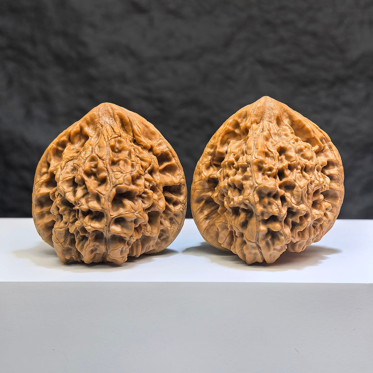 Pair of Classic Scholar Wenwan walnuts by Wenwan Art, 47mm x 44mm, featuring 麒麟紋凹底 design, hand-matched walnut sculptures.