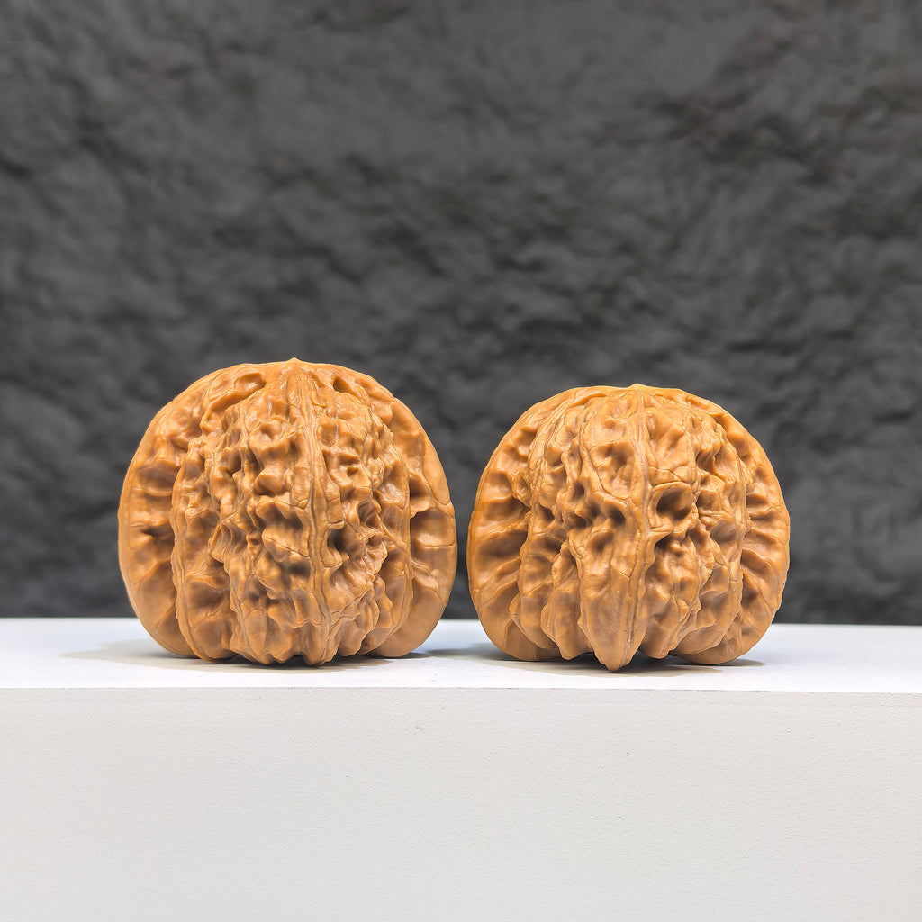 Pair of spherical white lion Wenwan walnuts from Wenwan Art, 41mm diameter, round profile with intricate white lion design.