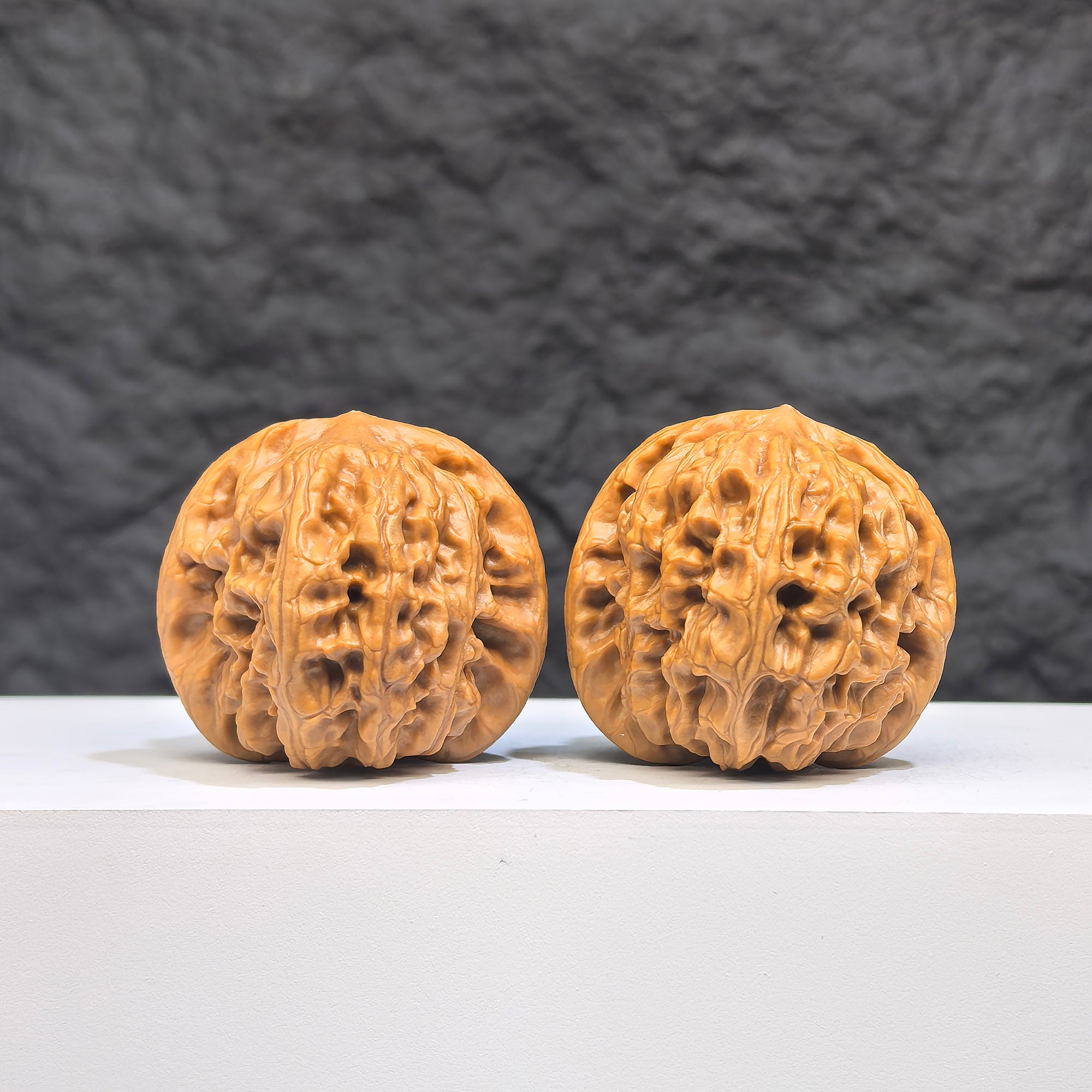 Pair of authentic Wild Wolf Wenwan walnuts from Wenwan Art, 37mm x 39mm, showcasing natural walnut features and craftsmanship