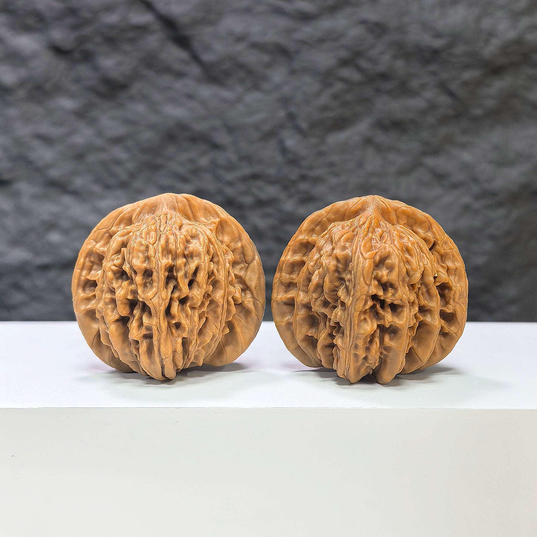 Pair of Sizuolou Classic Wenwan Walnuts from Wenwan Art, 39mm x 37mm, showcasing detailed carvings and smooth polished surfaces.