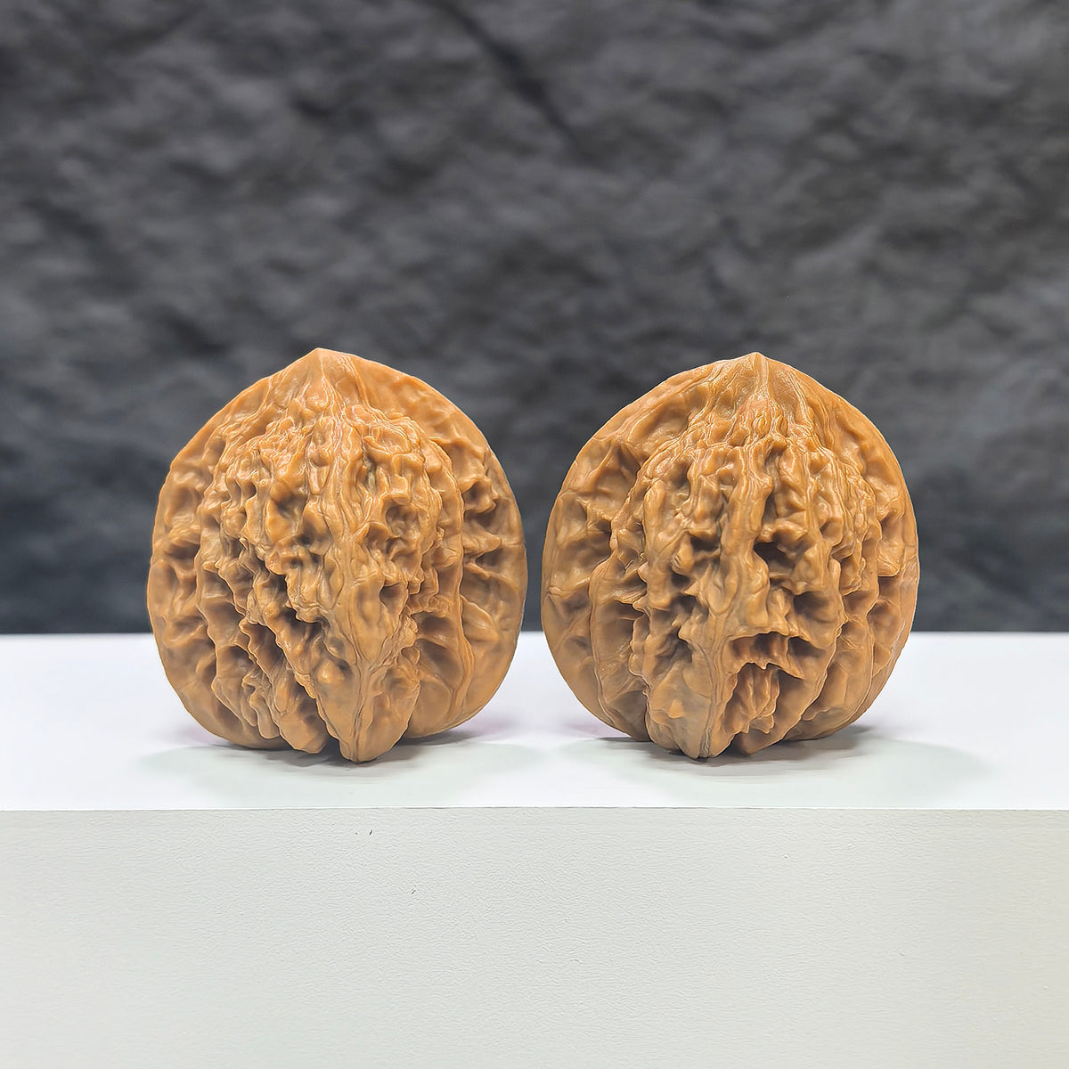 Pair of Xiayunling Classic Wenwan walnuts from Wenwan Art, 38mm x 37mm, showcasing smooth, polished walnut carvings.