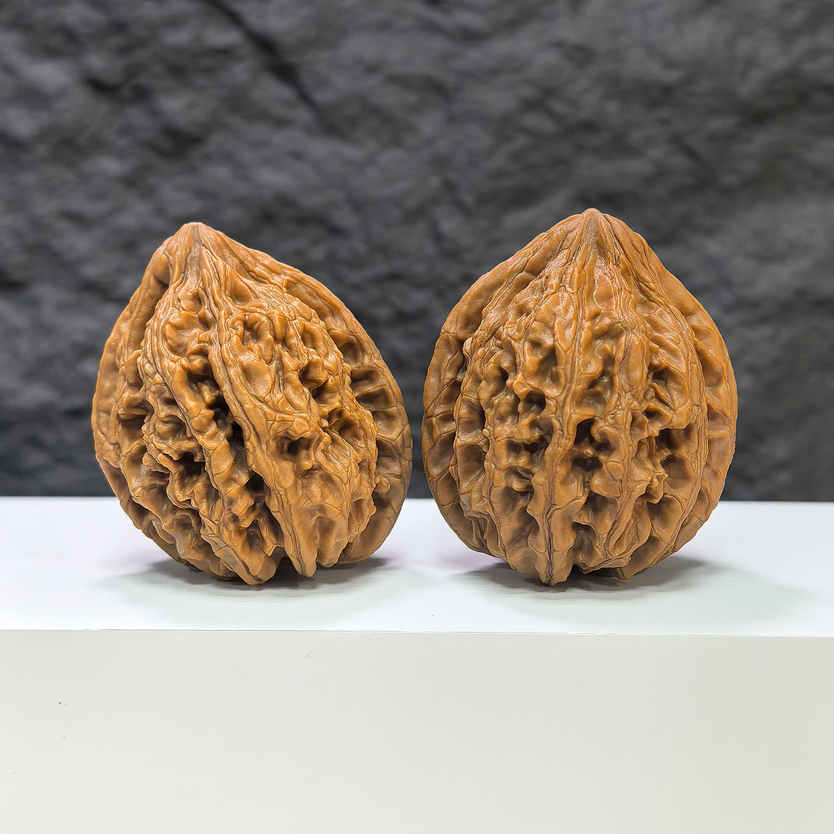 Pair of Sizuolou Wenwan walnuts by Wenwan Art, classic 41mm x 40mm walnut carvings with detailed natural wood grain.