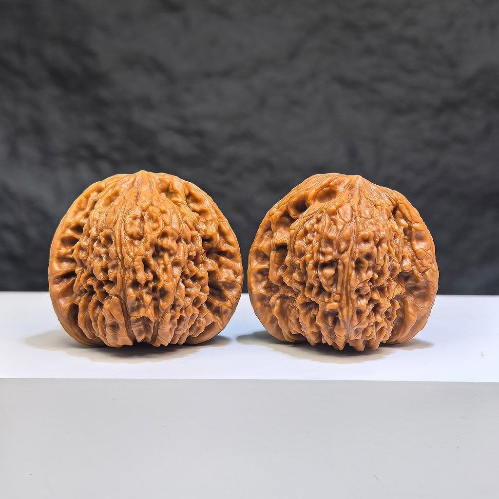 Pair of red shell Nanjiangstone Wenwan walnuts from Wenwan Art, 40mm x 38mm, showcasing intricate natural patterns and smooth finish.