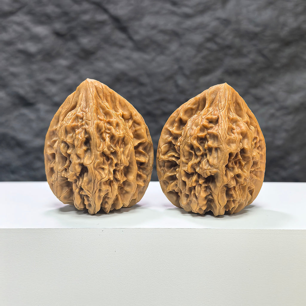 Pair of Beijing Chicken Heart Wenwan walnuts from Wenwan Art, 41mm x 40mm, featuring smooth, polished walnut carvings.