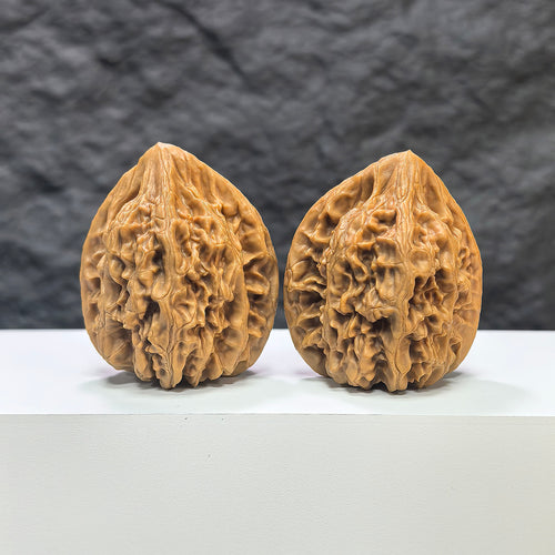 Pair of Beijing Chicken Heart Wenwan walnuts from Wenwan Art, 41mm x 40mm, featuring smooth, polished walnut carvings.