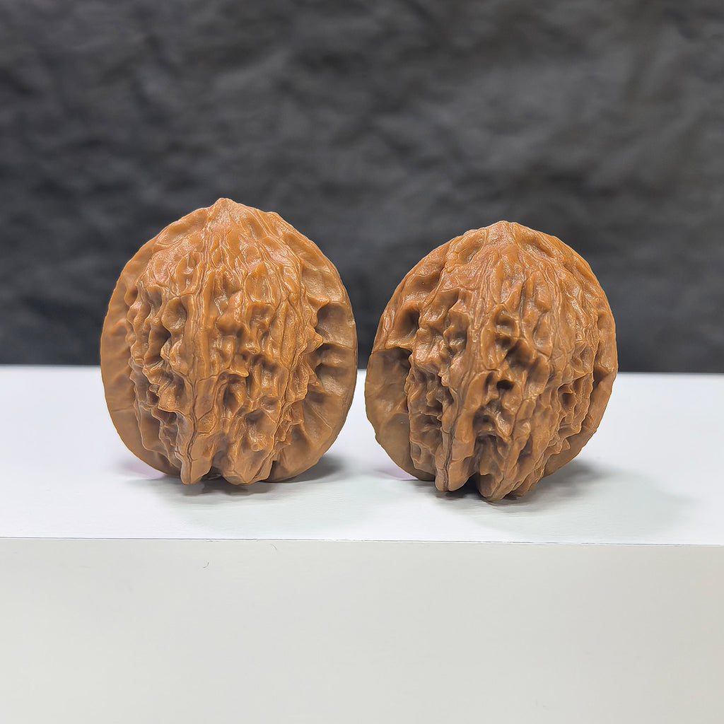 Pair of miniature Wenwan Walnut Pocket Phoenix Tail carvings by Wenwan Art, measuring 30x31mm, showcasing detailed craftsmanship.