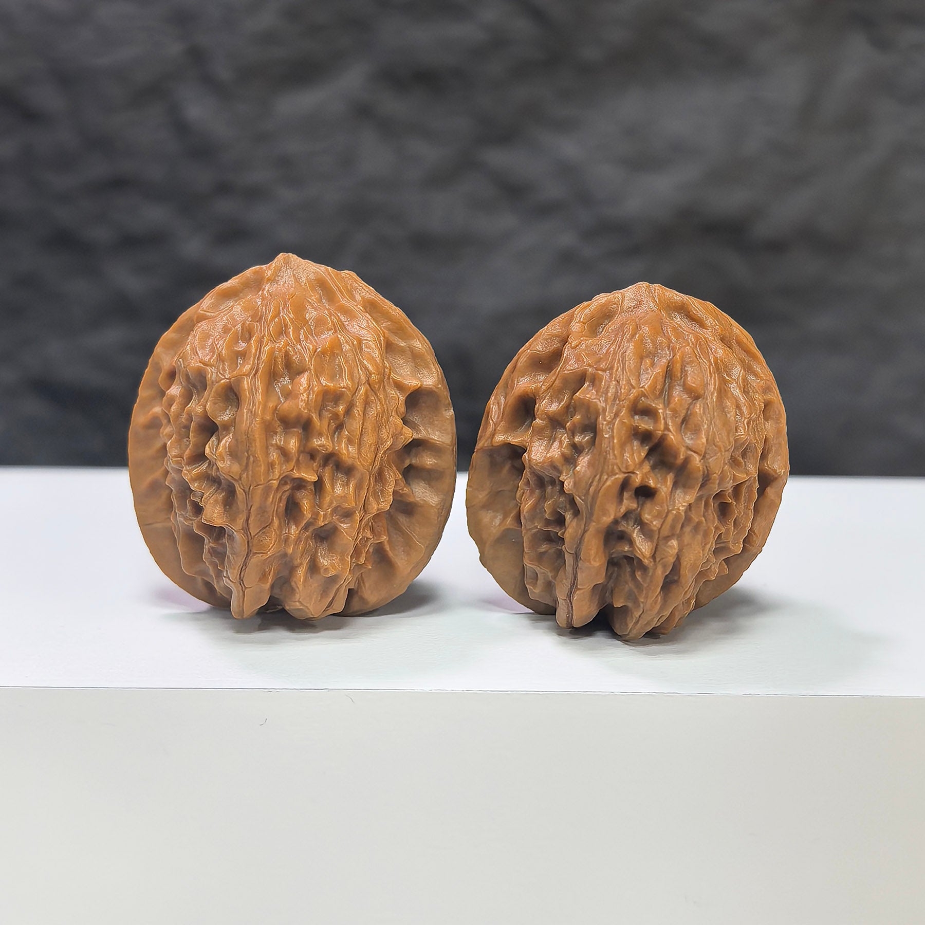 Pair of miniature Wenwan Walnut Pocket Phoenix Tail carvings by Wenwan Art, measuring 30x31mm, showcasing detailed craftsmanship.