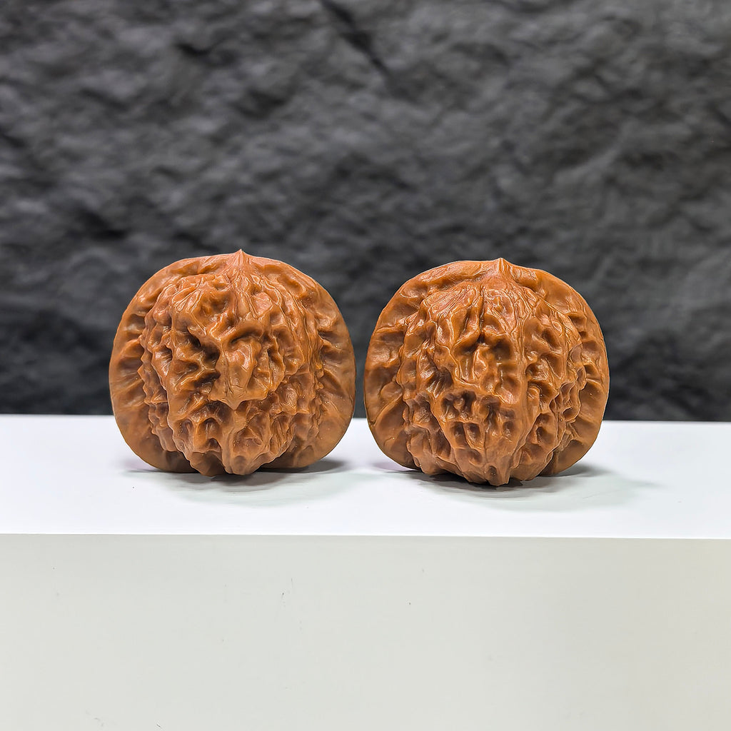 Pair of Wenwan Art porcelain doll-themed Wenwan walnuts, smooth-glaze finish, 38mm size, featuring detailed doll designs.