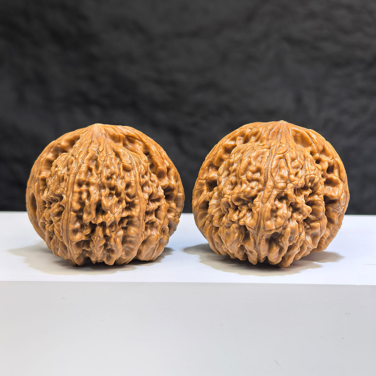 Pair of spherical Nanjiangstone Wenwan walnuts from Wenwan Art, round profile, 41mm x 43mm, showcasing smooth, polished stone surfaces.