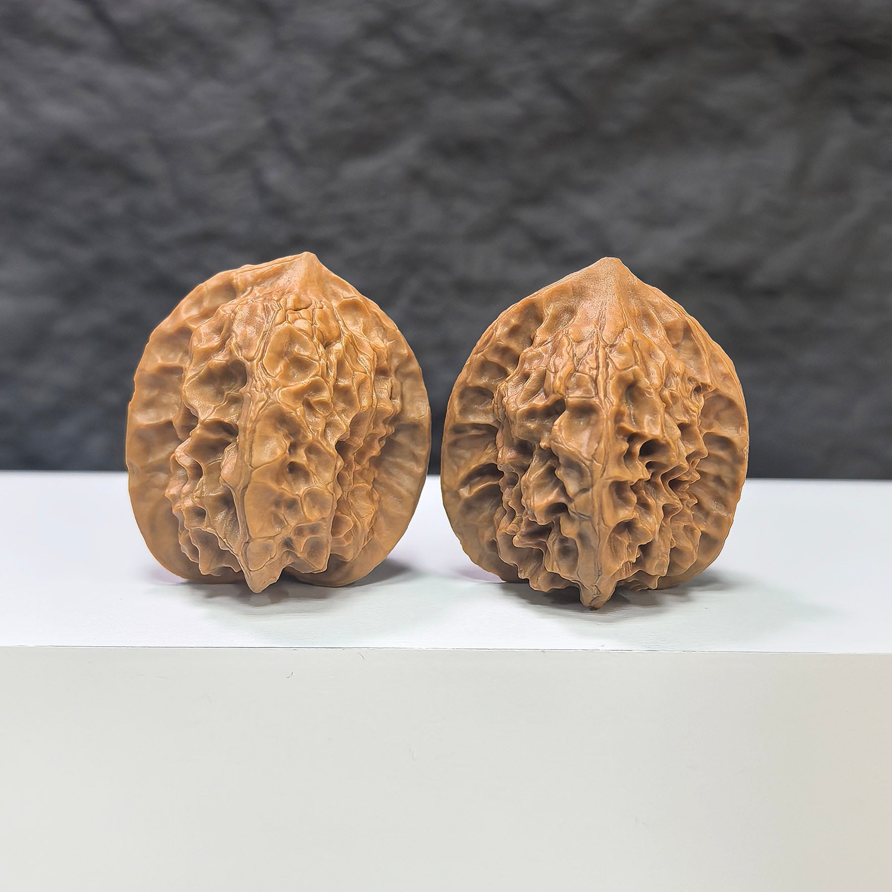 Pair of Linglong x White Snake Valley Wenwan walnuts by Wenwan Art, 33mm x 35mm, showing intricate natural walnut patterns.