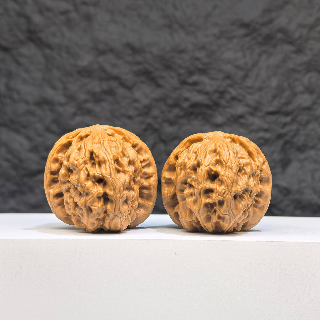 Pair of authentic Wild Wolf Wenwan walnuts by Wenwan Art, showcasing natural wood grain and size of 38mm x 40mm.