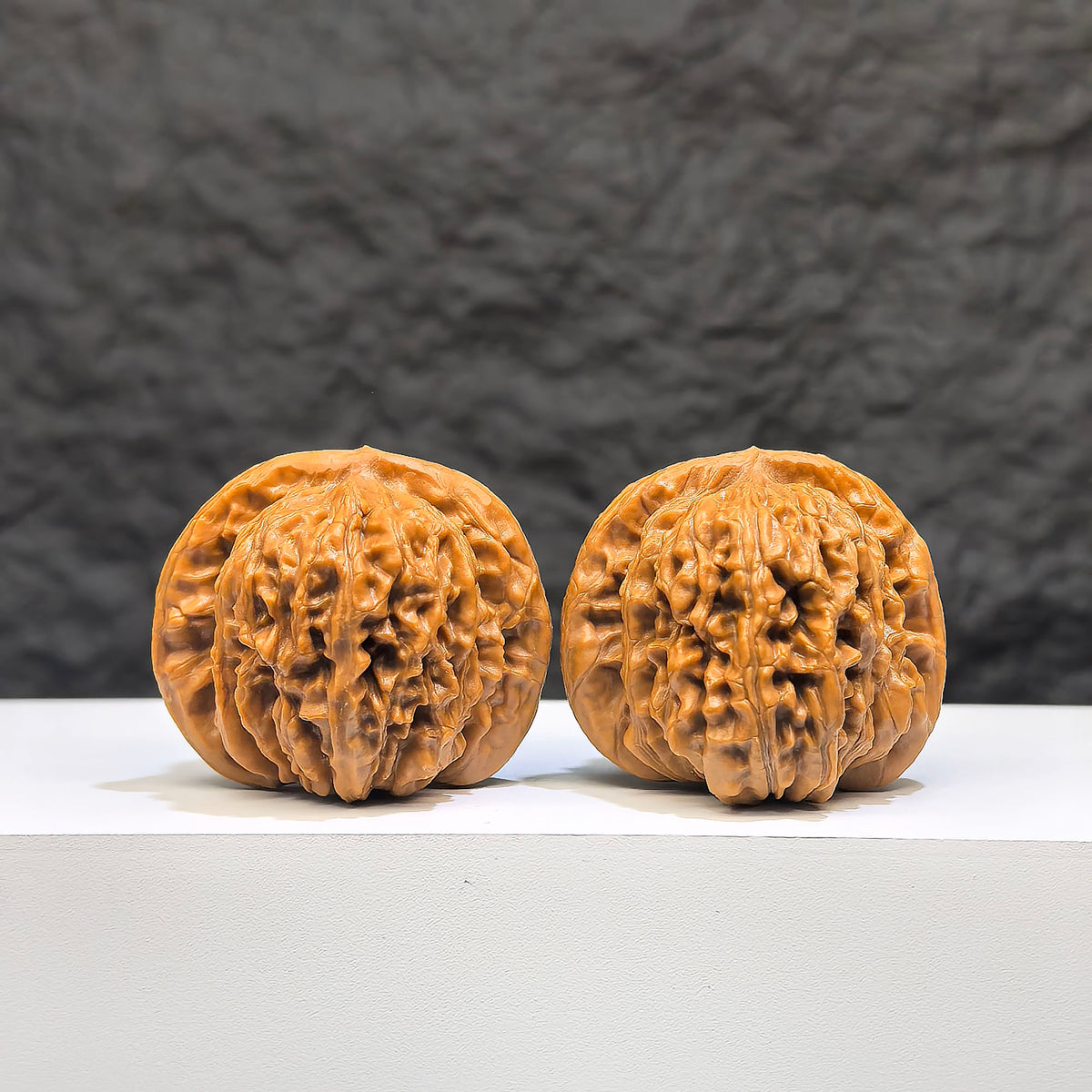 Pair of Sizuolou Wenwan Walnuts by Wenwan Art, classic 40mm x 37mm, featuring detailed natural walnut carvings and smooth surfaces.
