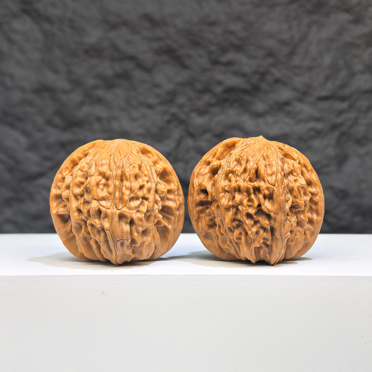 Pair of Wenwan Art Millstone Classic Wenwan walnuts, 37mm x 34mm, featuring detailed carvings and smooth polished surfaces.